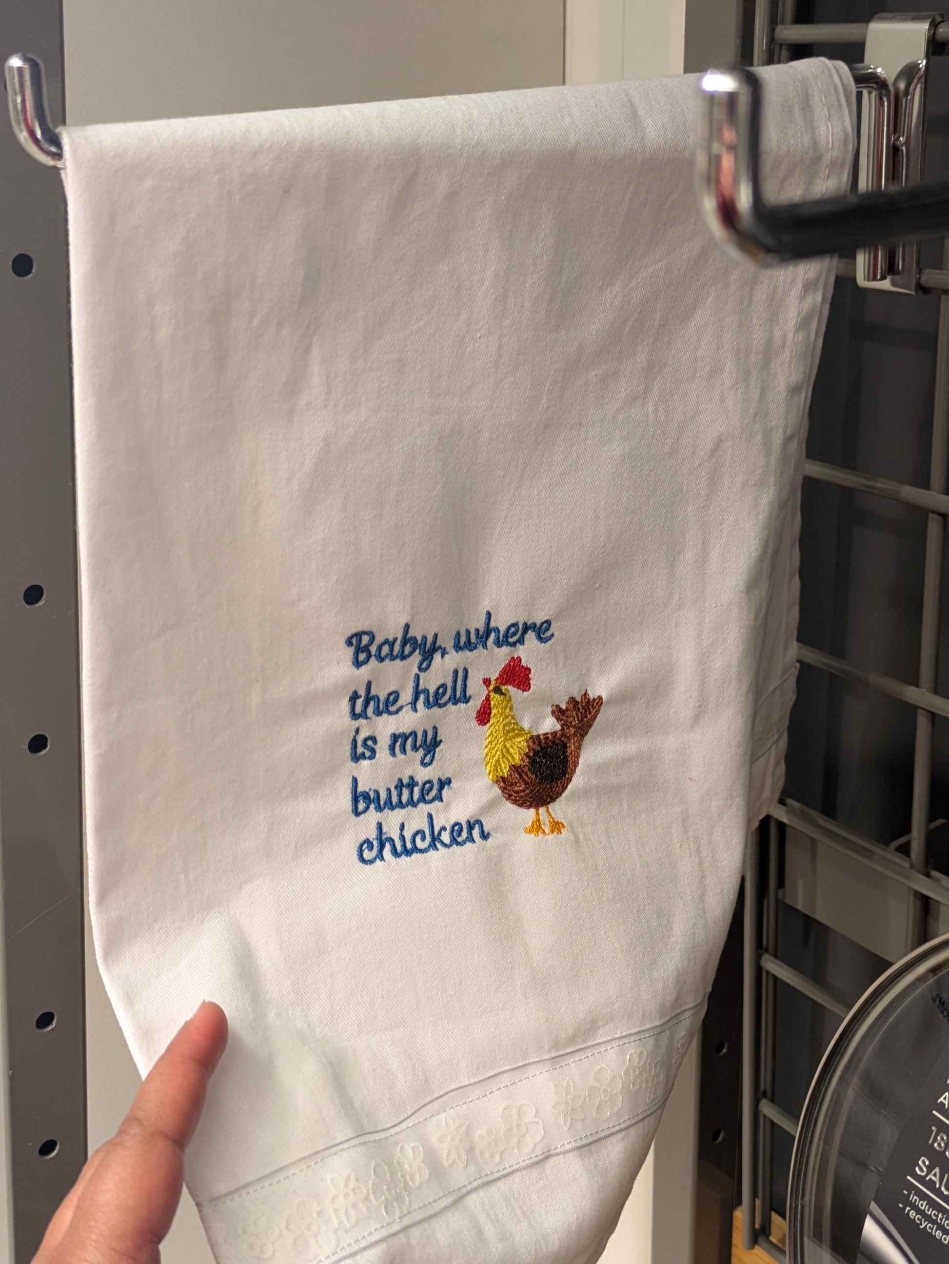 Baby butter chicken tea towel by Bobbin Heads featuring a playful, colorful design with butter chicken illustrations.